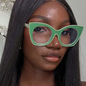 Cat eye blue light blocking glasses with green frames worn by a female model