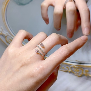 Detail of a 925 silver snake wrap ring featuring pink pear-cut stones and white zircon stones