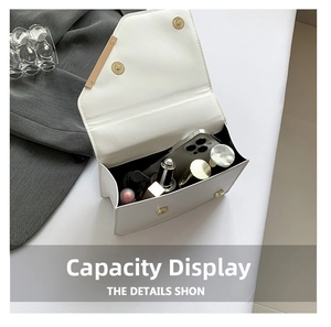 Internal view of a white crossbody bag showing capacity for a smartphone and cosmetics
