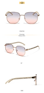 Detail view of square oversized sunglasses with chain link temples and orange-grey gradient lens