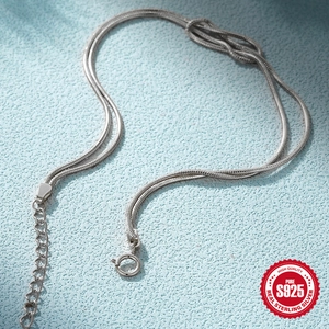 Elegant S925 sterling silver snake chain necklace with a unique knot design in silver finish