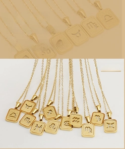 Detailed view of 12 gold plated zodiac hollow square necklaces in stainless steel