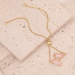 Detail of an 18K gold butterfly bracelet with pink crystals and adjustable clasp