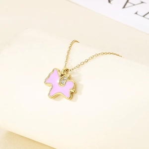 Detail of pink unicorn pendant with gold plating and crystals on a fine chain