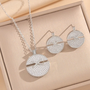 Elegant silver round cross necklace and earrings set with sparkling zircon in a beige box