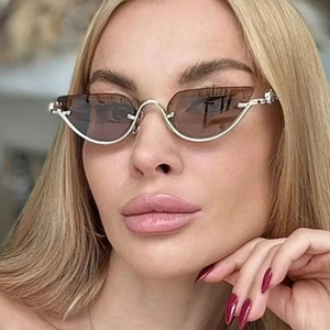 Chic silver metal cat-eye sunglasses with brown lenses shown on a female model