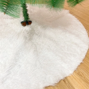 Detail of soft white plush Christmas tree skirt on rustic wooden floor with long faux fur