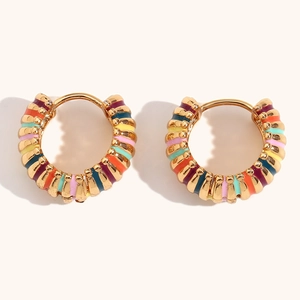 Macro shot of colorful enamel striped gold hoop earrings with secure clasp closure