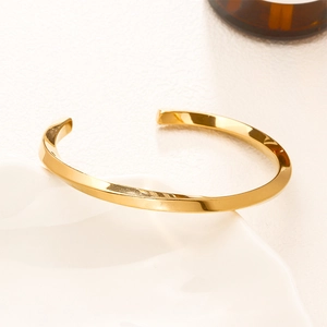 Golden Mobius twist open bangle in polished titanium steel for men and women