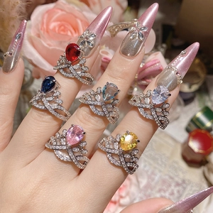 Detail of six crown rings with pear-cut gemstones in red, blue, pink, and yellow shades