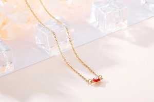 Macro detail of red evil eye pendant with gold link chain on decorative petals