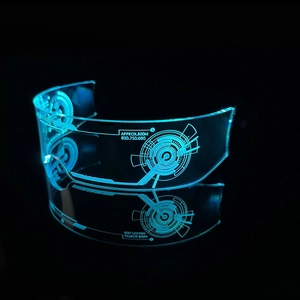 Macro detail of cyberpunk LED glasses with blue glow and futuristic laser engraved patterns