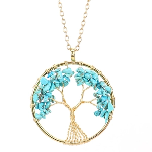 Macro detail of handmade wire wrapped tree of life pendant with blue crystal stones