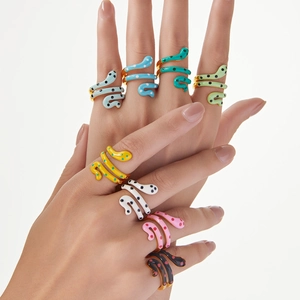 Colorful enamel snake rings with dot patterns in gold plating for a minimalist layered look