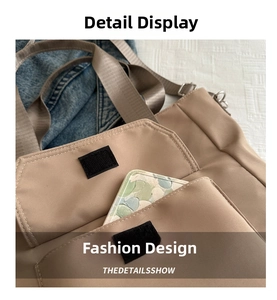 Detail of khaki nylon tote bag with functional velcro front pocket and sleek design