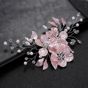Detailed close-up of handmade bridal hair clip with pink resin petals and crystal beads