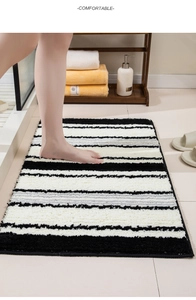 Close-up of plush striped bathroom mat showing absorbent texture and anti-slip backing