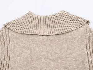 Detailed close-up of oatmeal ribbed knit collar and high-quality fabric texture