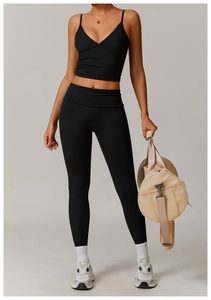 Detail of black deep V-neck crop top and high-waist leggings set for professional fitness