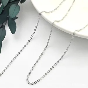Detailed close-up of a polished S925 sterling silver O-chain necklace on a white ceramic plate