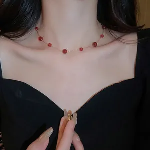 Elegant gold plated necklace with red agate beads shown on a model for a vintage look
