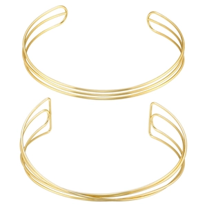 Detailed view of two minimalist golden metal wire open collars with a striped geometric design