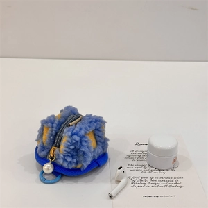 Blue and yellow waffle fleece AirPods case with pearl zipper and D-ring hook detail