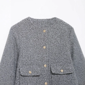 Women's grey bouclé jacket featuring elegant gold buttons and textured knit design