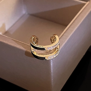 Macro shot of gold-plated double-layer C-shape ear cuff with cubic zirconia accents