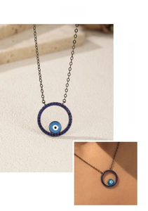 Detail of blue evil eye pendant with dark gunmetal chain and bohemian style crystals