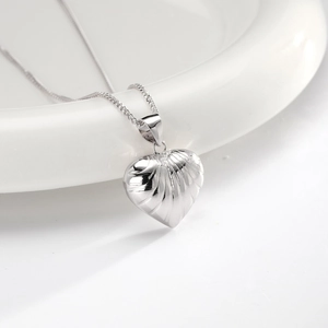 Detailed macro shot of a S925 silver heart necklace with unique radial textured pattern