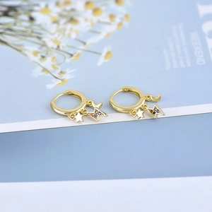 Detail of gold hoops with moon star and rainbow stone lightning charms on cards