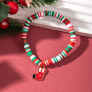 Close-up of colorful clay beaded Christmas bracelet with a red stocking pendant