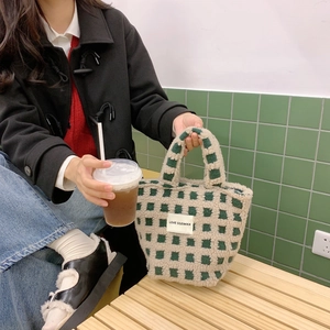 Detail of green waffle pattern shearling tote bag with Love Sozakka brand tag