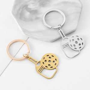 Pickleball paddle and ball keychain in gold and silver finish on marble base