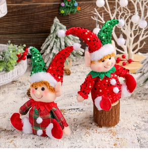 Close-up of sitting Christmas gnomes with sequins and red-green plaid fabric details
