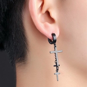 Close-up of matte black stainless steel clip-on earring with chain and cross pendants