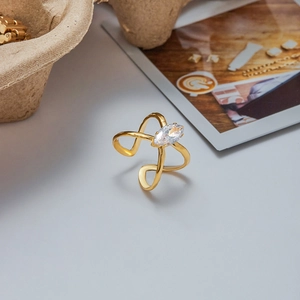 Close-up of golden marquise-cut zircon ring on a natural eco-friendly tray background