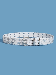 Detail view of white belt with silver star rivets and sparkling sequins on blue background