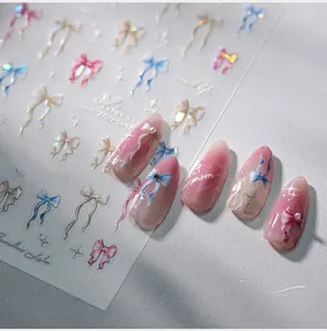 Detail of M-643 bow nail art stickers with aurora pearls and 3D effect on pink nails