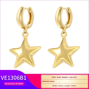 Detailed view of gold star drop earrings in brass with size and weight dimensions
