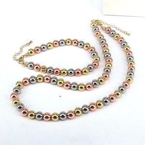 Three-tone beaded jewelry set with gold silver and rose gold polished metal spheres