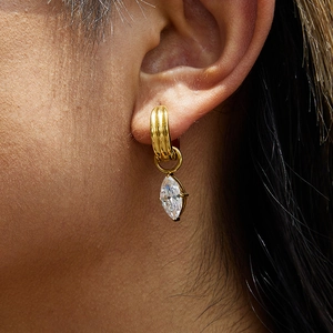 Close-up of 18K gold stainless steel hoop earrings with marquise-cut zircon drop on ear