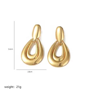 Detailed view of gold tiered teardrop earrings with dimensions 5.6cm by 2.8cm