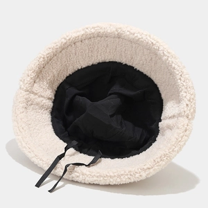 Thick warm cream faux fur bucket hat with adjustable inner lining and black drawstrings