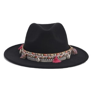 Detail of black felt fedora with bohemian woven band, colorful tassels, and white shells