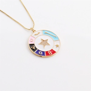 Macro view of gold necklace with colorful enamel star and zircon skull charm