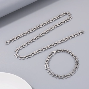 Minimalist silver titanium steel necklace and bracelet set with hollow bone-shaped links