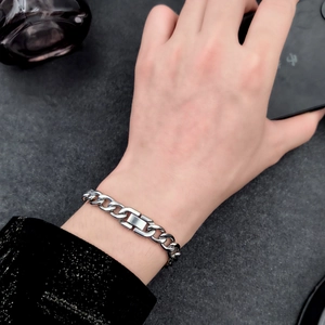 Men's silver stainless steel Cuban link bracelet with rectangle buckle on wrist