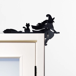 Detailed view of black witch and cat acrylic silhouette on white door frame corner